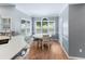 Cozy breakfast nook with a white table set, large windows, and wood-look flooring at 3898 Heritage Oaks Dr, Powder Springs, GA 30127