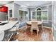 Cozy breakfast nook with a white table set, large windows, and wood-look flooring at 3898 Heritage Oaks Dr, Powder Springs, GA 30127