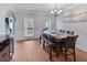 Dining room features wood floors, large windows, and modern lighting at 3898 Heritage Oaks Dr, Powder Springs, GA 30127