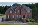 Classic two-story brick home with tidy landscaping and a welcoming front entrance at 3898 Heritage Oaks Dr, Powder Springs, GA 30127
