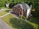 Two-story brick home with landscaped front yard, dark shutters, and a manicured lawn at 3898 Heritage Oaks Dr, Powder Springs, GA 30127