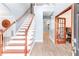 Inviting foyer with hardwood floors, staircase, and glass-paneled door to an office at 3898 Heritage Oaks Dr, Powder Springs, GA 30127