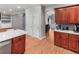 Open-concept kitchen features cherry wood cabinets and a white quartz breakfast bar at 3898 Heritage Oaks Dr, Powder Springs, GA 30127