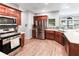 Bright kitchen featuring stainless steel appliances, cherry wood cabinets, and quartz countertops at 3898 Heritage Oaks Dr, Powder Springs, GA 30127