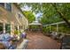 Beautiful backyard deck with outdoor seating, dining under gazebo, water feature, lush landscaping, and a welcoming ambiance at 540 Shale Ct, Alpharetta, GA 30022