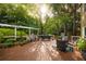 Expansive backyard deck featuring outdoor seating, a grill, potted plants, and a 'welcome' pergola for entertaining at 540 Shale Ct, Alpharetta, GA 30022