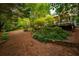 Backyard with tiered landscaping and a glimpse of a deck, offering a serene view of nature at 540 Shale Ct, Alpharetta, GA 30022