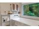 Relaxing bathroom featuring a standalone tub, picture window, and a built-in shelf with décor at 540 Shale Ct, Alpharetta, GA 30022