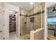 Elegant bathroom with a glass-enclosed shower, stone tiling, and view into the main bedroom at 540 Shale Ct, Alpharetta, GA 30022