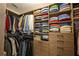 Walk-in closet featuring custom wood shelving, multiple hanging rods, and ample storage space at 540 Shale Ct, Alpharetta, GA 30022
