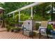 Relax on this deck with a beautiful water feature and chairs, surrounded by lush greenery and a pergola with 'welcome' sign at 540 Shale Ct, Alpharetta, GA 30022