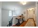 Upstairs hallway features hardwood floors, decorative table, stylish decor, staircase and a light-filled window at 540 Shale Ct, Alpharetta, GA 30022