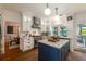 Well-lit kitchen with white cabinets, a center island, and access to the dining area at 540 Shale Ct, Alpharetta, GA 30022