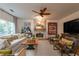 Cozy living room with stone fireplace, ceiling fan, large windows, comfortable seating, and stylish decor at 540 Shale Ct, Alpharetta, GA 30022