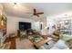 Open concept living room featuring fireplace, large windows, ceiling fan and views to the kitchen at 540 Shale Ct, Alpharetta, GA 30022
