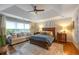 Spacious main bedroom featuring a cozy sitting area, ceiling fan, and elegant decor at 540 Shale Ct, Alpharetta, GA 30022