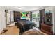 Spacious bedroom with hardwood flooring, a dark comforter, and bright light at 1192 Arlington Sw Ave, Atlanta, GA 30310
