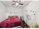 Bedroom with red comforter, decorated walls, and a ceiling fan at 1192 Arlington Sw Ave, Atlanta, GA 30310