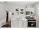 Efficient kitchen with white cabinets, stainless sink, and modern black oven range at 1192 Arlington Sw Ave, Atlanta, GA 30310