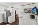 Bright kitchen features white cabinets, stainless steel refrigerator, and modern appliances at 1192 Arlington Sw Ave, Atlanta, GA 30310