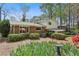 Charming backyard featuring mature trees and bushes, colorful flowering plants, and house at 2516 Cherry Hill Ln, Atlanta, GA 30360
