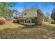 Charming backyard featuring a house, green grass, mature trees and bushes, and colorful flowering plants at 2516 Cherry Hill Ln, Atlanta, GA 30360