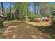 Well-maintained backyard with mature trees, flowering bushes, and fresh mulch at 2516 Cherry Hill Ln, Atlanta, GA 30360