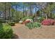 Well-maintained backyard with mature trees, flowering bushes, and fresh mulch at 2516 Cherry Hill Ln, Atlanta, GA 30360