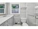 Modern bathroom featuring gray vanity, updated fixtures, and glass-enclosed shower stall at 2516 Cherry Hill Ln, Atlanta, GA 30360