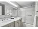 Bathroom featuring double sinks, marble countertop, a large mirror, and shower with sliding glass doors at 2516 Cherry Hill Ln, Atlanta, GA 30360