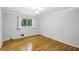 Bright bedroom with hardwood floors, a large window overlooking nature, and soft natural light at 2516 Cherry Hill Ln, Atlanta, GA 30360