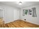 Bright bedroom featuring hardwood floors, neutral walls, window with curtains, and closet at 2516 Cherry Hill Ln, Atlanta, GA 30360