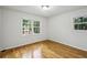 Bright bedroom with hardwood floors, two large windows with views of the outside greenery at 2516 Cherry Hill Ln, Atlanta, GA 30360