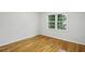 Bedroom featuring hardwood floors, white trim, neutral walls, and window to let in natural light at 2516 Cherry Hill Ln, Atlanta, GA 30360