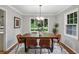 Elegant dining room featuring a modern light fixture, a large window, and a stylish wooden table for gatherings at 2516 Cherry Hill Ln, Atlanta, GA 30360