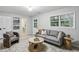 Cozy living room features modern gray sofa, stylish armchair, and round wooden coffee table on neutral rug at 2516 Cherry Hill Ln, Atlanta, GA 30360