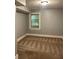 This basement bedroom offers a window for natural light and patterned carpeting at 2855 Peachtree Ne Rd # 106, Atlanta, GA 30305