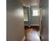 Hallway featuring hardwood floors, neutral paint, and access to other rooms, offering a clean transition at 2855 Peachtree Ne Rd # 106, Atlanta, GA 30305