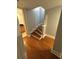Bright hallway with hardwood floors leading to carpeted stairs at 2855 Peachtree Ne Rd # 106, Atlanta, GA 30305