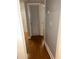 Hallway with wood flooring features a louvered door and white trim at 2855 Peachtree Ne Rd # 106, Atlanta, GA 30305