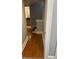 Bright hallway featuring hardwood floors, leading to a bathroom with modern fixtures at 2855 Peachtree Ne Rd # 106, Atlanta, GA 30305