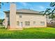 View of the home's rear exterior, including a spacious yard and patio area at 3731 Laramie Rd, Ellenwood, GA 30294