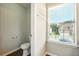 Bright half bathroom featuring a window and light walls, plus modern fixtures at 3731 Laramie Rd, Ellenwood, GA 30294