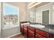 Bathroom featuring double sinks, granite countertops and a view to the neighborhood at 3731 Laramie Rd, Ellenwood, GA 30294