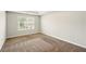 Bedroom featuring neutral carpet, light walls, and a window, plus trim molding at 3731 Laramie Rd, Ellenwood, GA 30294