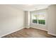 Bedroom featuring wood-look flooring, neutral paint, and large window at 3731 Laramie Rd, Ellenwood, GA 30294