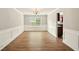 Dining room featuring wood-look flooring, white trim, and a chandelier at 3731 Laramie Rd, Ellenwood, GA 30294