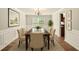 Elegant dining room with wainscoting, chandelier, and a large window overlooking the backyard at 3731 Laramie Rd, Ellenwood, GA 30294