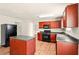 Kitchen featuring wood cabinets, laminate floors, and modern appliances at 3731 Laramie Rd, Ellenwood, GA 30294