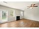 Living room features wood-look flooring, fireplace, ceiling fan and a door to the back at 3731 Laramie Rd, Ellenwood, GA 30294